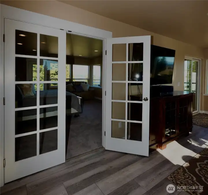 Charming French doors leads you into a spacious  bedroom in penthouse with 2 balconies and stunning views from this top floor