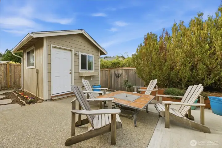 Step outside to your patio and enjoy the sunshine and privacy.  That shed has electric and heat.
