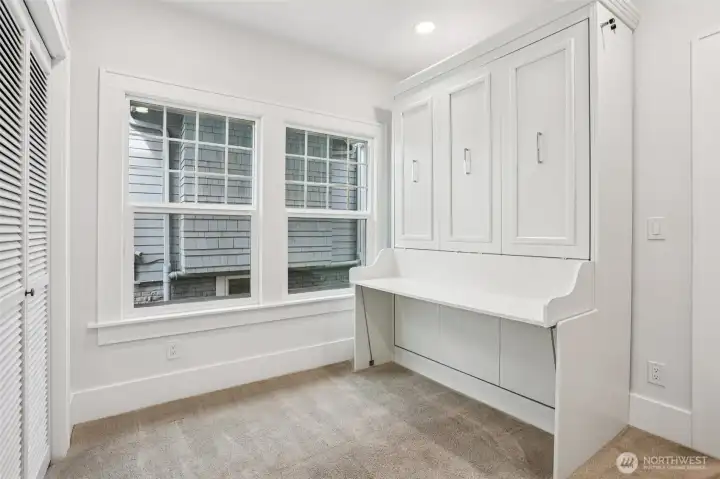 Main floor bedroom 1 with build in murphy bed.