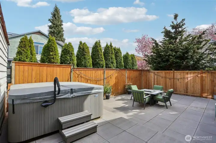 Private fully fenced back yard with hot tub.