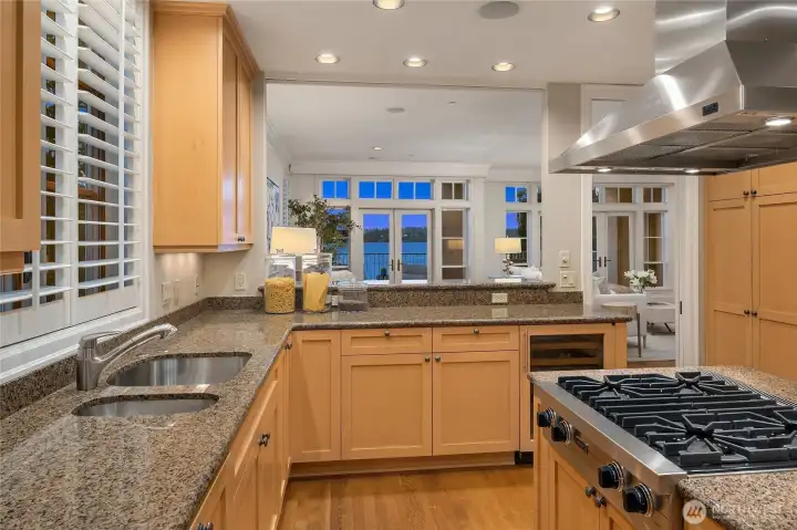 Located just off the dining area and across from the living room, the kitchen is designed with both functionality and connection in mind.  Warm finishes and generous workspace make it ideal for daily living.