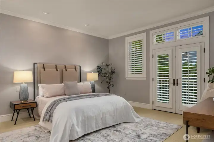 The first guestroom offers a bright and comfortable space for visitors, with large windows and an inviting feel.