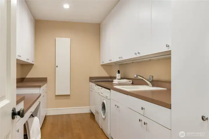 The laundry room offers additional storage, thoughtfully designed for everyday convenience.