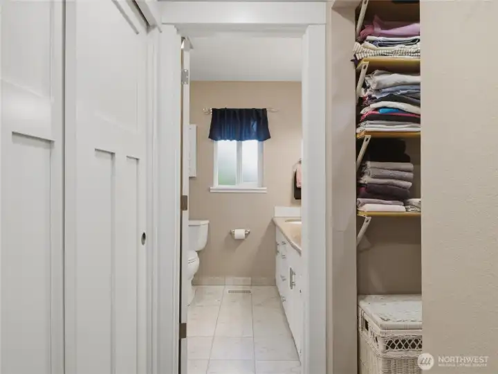 A walk thru closet to the Primary Bath with shower and tub