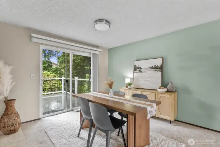sliding glass doors lead to balcony that overlooks the private fenced backyard