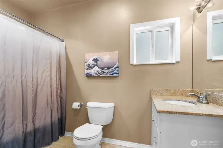 Full bathroom with granite countertop. Full bathroom with granite countertop.