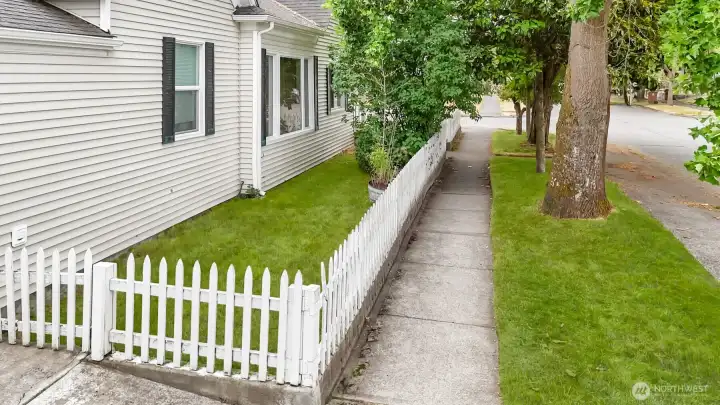 White picket fence allows you to keep all your four-legged friends secured for peace of mind. White picket fence allows you to keep all your four-legged friends secured for peace of mind.