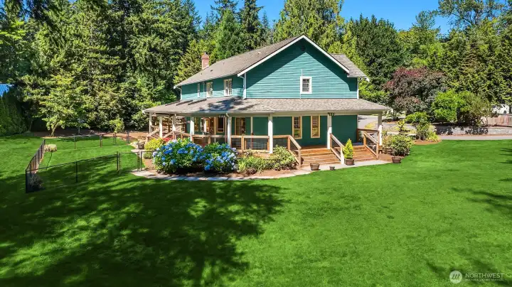 Charming side view of the wraparound covered porch that is so welcoming and inviting Charming side view of the wraparound covered porch that is so welcoming and inviting