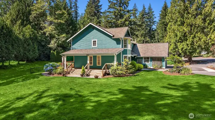 Spacious backyard offers open green space surrounded by established landscaping and towering evergreens. Spacious backyard offers open green space surrounded by established landscaping and towering evergreens.