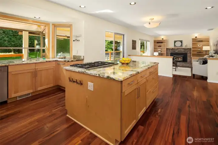 Updated kitchen features a center island, abundant cabinetry, hardwood floors, and open sightlines Updated kitchen features a center island, abundant cabinetry, hardwood floors, and open sightlines
