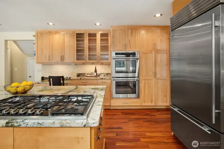 Gourmet kitchen includes premium appliances, generous prep space, and custom wood cabinetry Gourmet kitchen includes premium appliances, generous prep space, and custom wood cabinetry