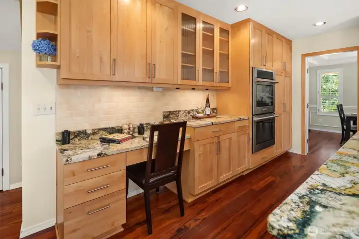 Spacious kitchen with breakfast bar, hardwood floors, and convenient access to adjoining living areas. Spacious kitchen with breakfast bar, hardwood floors, and convenient access to adjoining living areas.