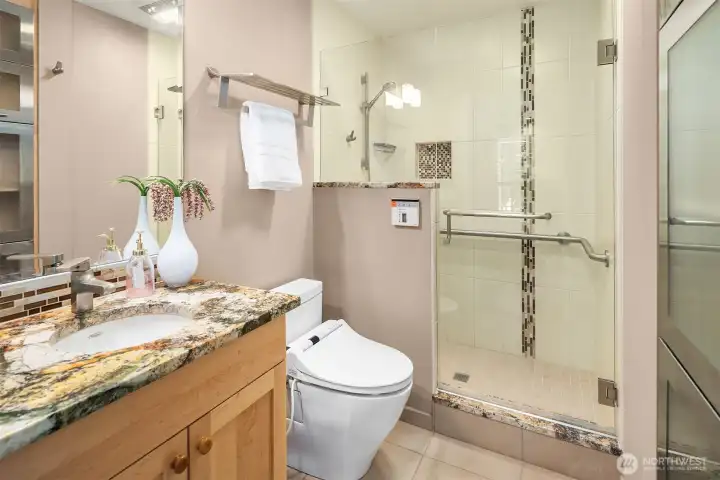 Updated bathroom features granite counters, a large walk-in shower, and modern finishes. Updated bathroom features granite counters, a large walk-in shower, and modern finishes.