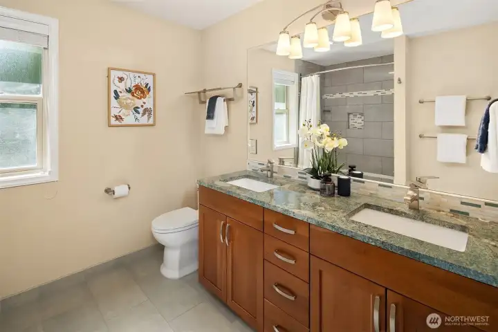 Bathroom features dual sinks, extensive vanity storage, and updated lighting Bathroom features dual sinks, extensive vanity storage, and updated lighting