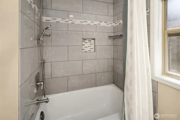 Tile shower with built-in niche and modern fixtures Tile shower with built-in niche and modern fixtures