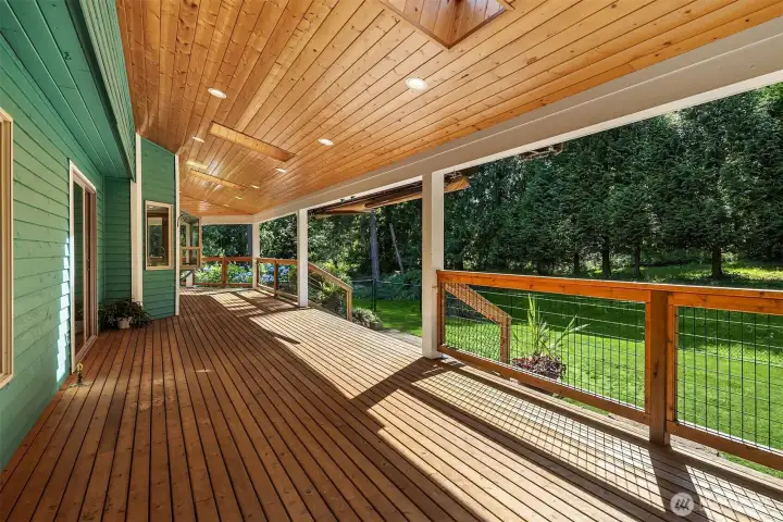 Expansive deck offers multiple seating areas and overlooks the beautifully landscaped grounds Expansive deck offers multiple seating areas and overlooks the beautifully landscaped grounds