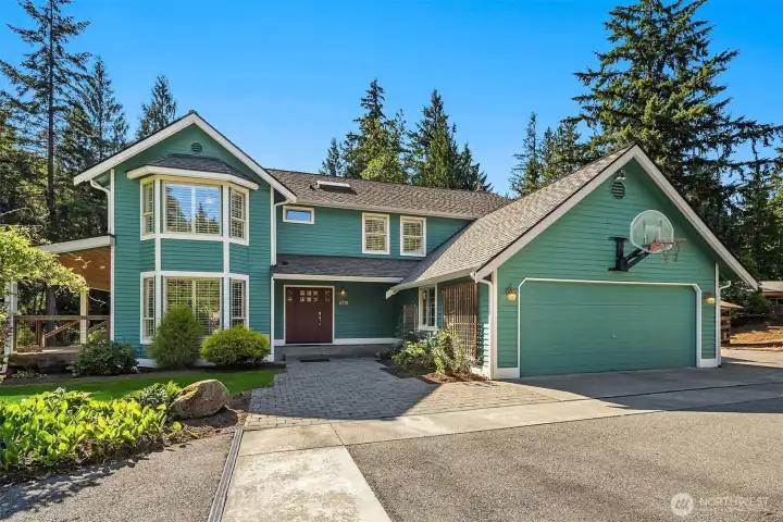 Beautiful front exterior showcases mature landscaping, generous driveway, and attached garage. Beautiful front exterior showcases mature landscaping, generous driveway, and attached garage.