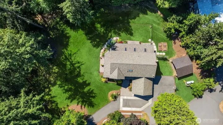 Aerial view highlights the home's setting on approximately 1.5+ acres surrounded by greenery Aerial view highlights the home's setting on approximately 1.5+ acres surrounded by greenery