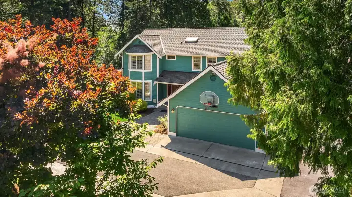 Aerial perspective highlights the home's private setting among mature trees. Aerial perspective highlights the home's private setting among mature trees.