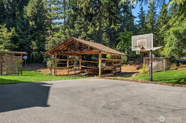 Detached outbuilding and additional covered parking provide versatile storage and workspace options Detached outbuilding and additional covered parking provide versatile storage and workspace options