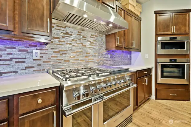 Gourmet kitchen with all high-end appliances all new kitchen with very custom cabinets 4 ovens 1 is high output oven 5 burner stove with large grill and commercial fan vent hood. cabinets have pull out drawers, spice cabinet and duoble dishwasher.