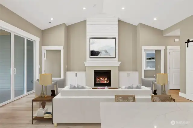 The vault in this room is emphasized by white shiplap above the masonry-faced gas fireplace. Additional Huntwood cabinets set off the fireplace.