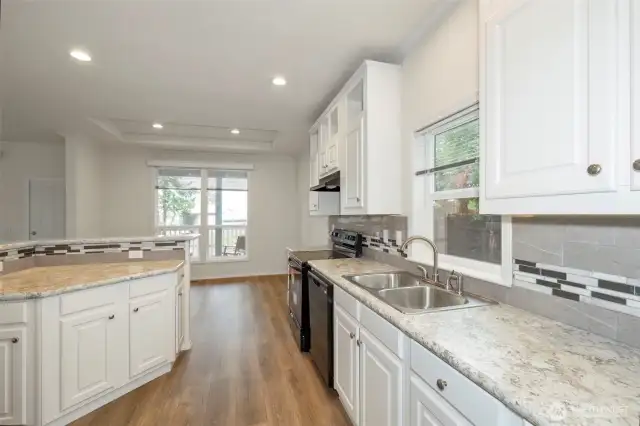 Upgraded counters, tile trim, and tall kitchen sink faucet
