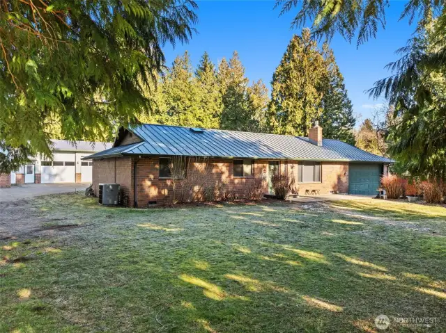 The Residential home is a solid brick rambler (1980) -3 bedrooms 2 & 3/4 bath - with updated systems; including an on-demand water heater, forced-air heat pump/air conditioning, propane gas fireplace, & private well (off-grid water system). Home has wood-plank flooring, vaulted ceilings & skylights, washer & dryer, & attached oversized 2-car garage with more storage & built-ins.