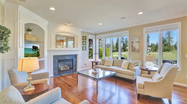Family room features a gas fireplace and wood encased detailing.