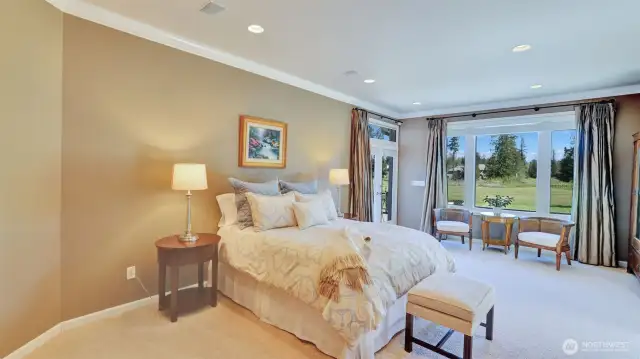 Spacious primary bedroom on the main floor with sitting area and gorgeous views.