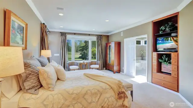 Elegant crown molding and built-ins highlight the primary suite.