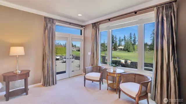 Primary suite enjoys access to the expansive patio and golf course views