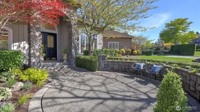 Attention to detail in this elegant walkway, hardscape, and professionally landscaped yard.