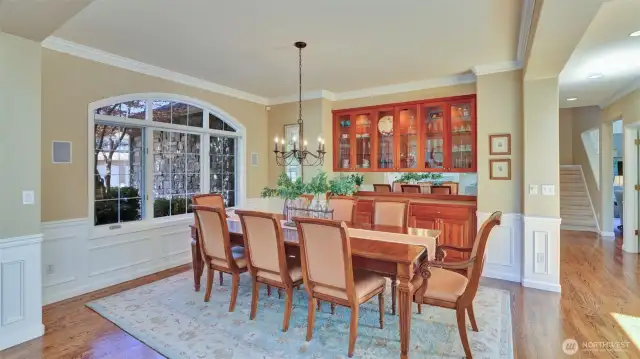 Formal dining area features built in cabinetry with a marble top serving area.