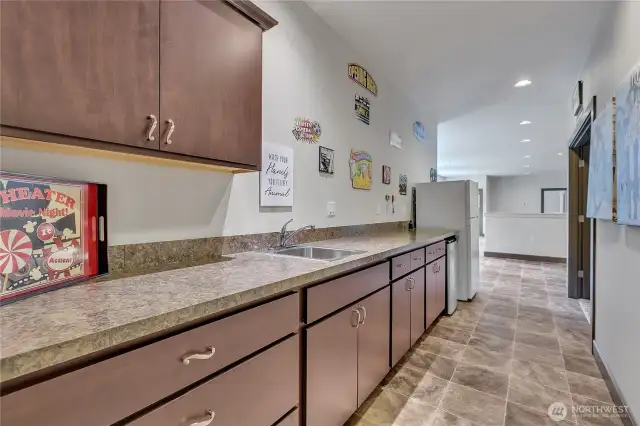 Kitchenette outside theater, half bath as well