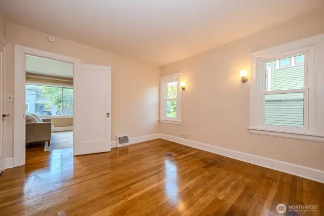 Bedroom #1 is accessed from the Living Room OR the main floor hallway. It is spacious bright and airy and the door to the left opens to a walk-in closet with built-ins.