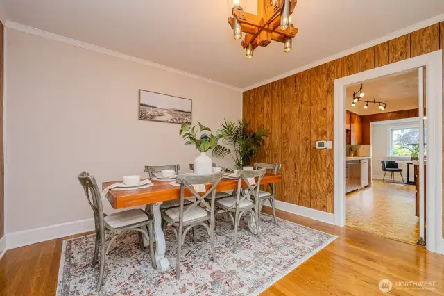 The Dining Room is located between the entry and the Kitchen. It is spacious and features a combination of plaster and wood paneled walls. A swinging door opens with ease into the kitchen.