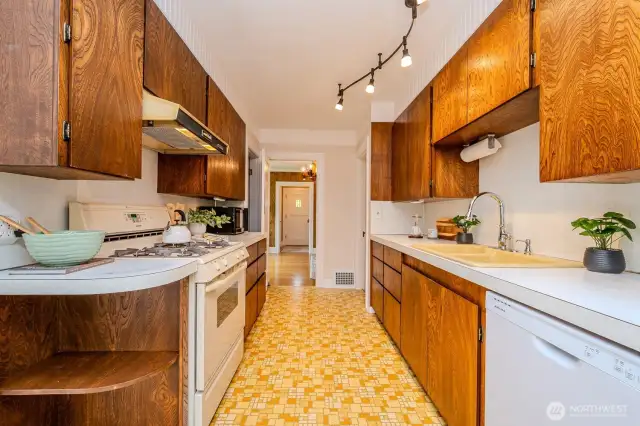 Looking back through the Kitchen and Dining Room to the Entry... All appliances convey with the home.