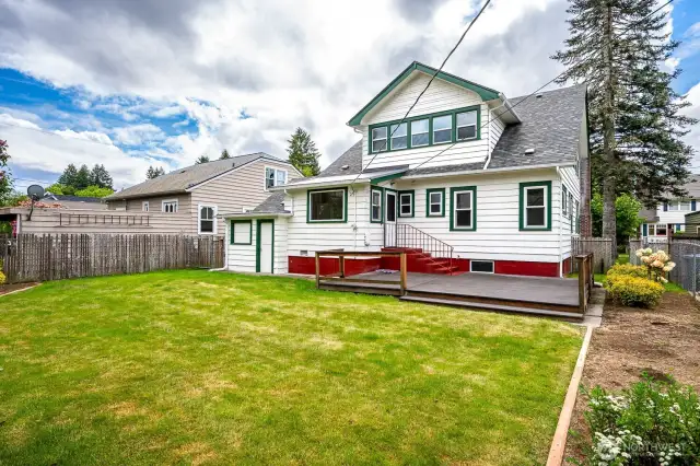 The backyard is fully fenced and features an expansive Trex deck off the Kitchen Nook, a generous lawn, garden space and mature, blooming shrubbery!
