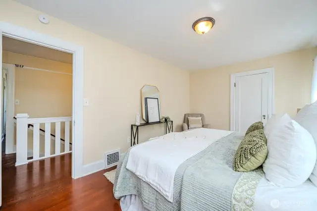 From the Primary Bedroom (Bedroom #4) doorway you see the beautiful white stairway to the main floor.