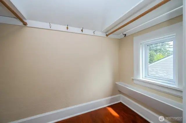 One of 2 walk-in closets in the Primary Bedroom... Notice the shoe rack under the window to the right. Love the natural light from windows in every walk-in closet!