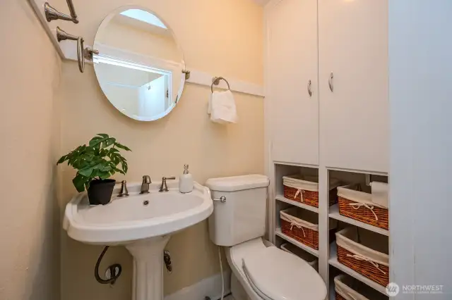 Toward the end of the upstairs hallway is this charming Half Bath. Note the built-in linen cabinet and open shelving for stylish, convenient storage!