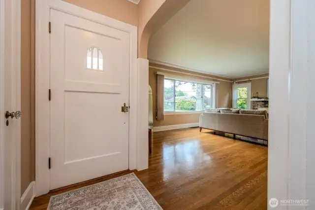 Just inside the front door you'll notice gleaming, original hardwood floors, arched doorways, large windows and stunning white 2-panel doors and millwork so characteristic of this era.