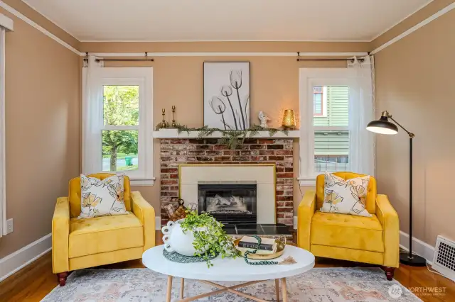 With the flip of a switch the cozy natural gas fireplace fills this space with warmth and a touch of timeless charm. Love the pretty red brick fireplace surround!