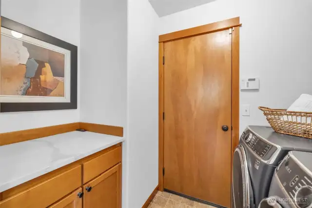 Laundry/mudroom off the garage has newer washer and dryer and great space for folding clothes and storing cleaning supplies