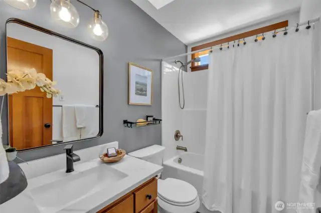 Hall bathroom has bath/shower combo and plenty of storage for all your bathroom needs