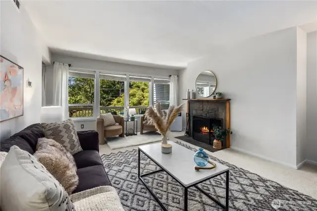 A cozy wood fireplace adds to the living room ambience