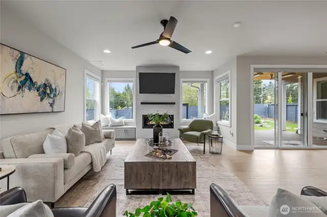 Open-concept living room with built-in bench and beautiful windows.