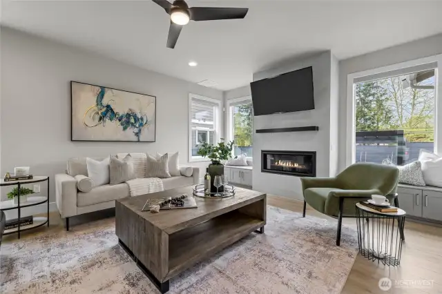Bright and spacious living room with fireplace – mounted TV stays!