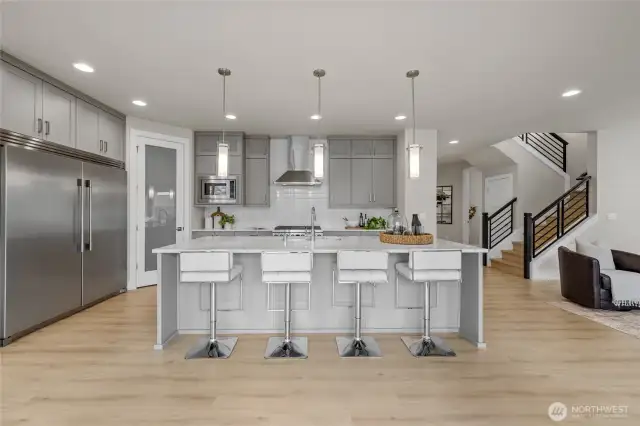 Stunning kitchen with full-height cabinets and huge built-in fridge.